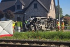 Several hurt in a crash between a train and a minibus, Belgian police say