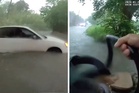 Baby rescued from car trapped in rising flood waters