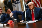 Trump uses key cabinet meeting to show off new $55 hats