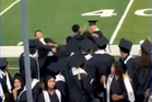 Wild brawl breaks out between cap-and-gown-wearing seniors as names are being called at their graduation
