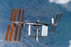 Space station astronauts stood ready to evacuate during air leak repairs