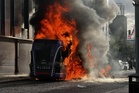 Bus set alight by masked protesters as police dealing with ‘pockets of disorder’