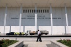 Workers prepare to remove Trump's name from the Kennedy Center, in photos