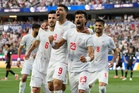 Iran opens its politically charged World Cup by playing to a 2-2 draw with New Zealand