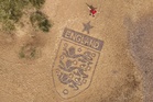 Artist crafts England badge on beach as World Cup campaign nears kick-off