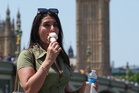 Britons stock up on fans, ice cream and silk scarves as intense heat grips country