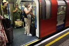 ‘There’s air con in the office’: Londoners brave commute despite 40C heat on tube