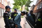 Football fans clash with police in the Hague after Netherlands suffer World Cup heartbreak
