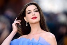 Anne Hathaway cradles baby bump at The Odyssey world premiere