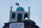 Loyalist bonfire lit early after police begin to remove mosque replica