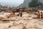 At least 12 dead in heavy rains across southern China and Vietnam
