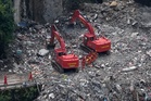 Rescuers in China search the rubble for survivors of landslide that killed 8 and left 34 missing