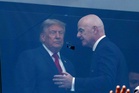 Trump pats FIFA trophy for good luck as he and Melania sit with Infantino behind protective glass at World Cup final