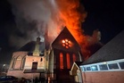 Firefighters race into burning church to rescue coffin from devastating fire