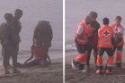 Collapsed migrant who swam to Ceuta aided by troops and medics amid border rush crisis