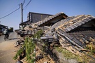 Prime minister visits quake-hit southern Japan as cleanup begins in intense heat