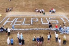 Angry villagers spell out ‘help us’ with plastic bottles after going days without water