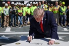 Trump brings trusty Sharpie on impromptu White House tour to sign helipad granite eagle