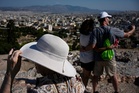 The sunhat is everywhere in Athens as crowds grow larger at ancient sites