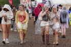 Festivalgoers braving rain and mud as thunderstorm warning in force