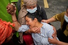 Photos show one family in Nepal bid farewell, as other flood victims are buried in unmarked graves