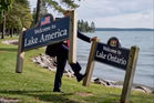 Trump reposts AI clip kicking over Lake Ontario sign after Carney demands the Americans ‘stop doing memes’