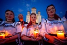 Photos of young Orthodox Christians taking part in a lights procession in Romania’s capital