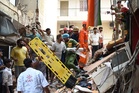 Building collapse in New Delhi kills 1 and traps others