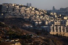 What are the Israeli settlements in the occupied West Bank and how could the UK sanction them?