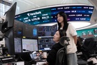 Asian shares fall and oil prices hold steady above $100 a barrel