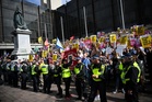 Burkha-wearing man charged with hiding identity at anti-migrant protest