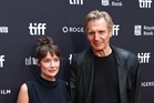 Liam Neeson and Stella Stocker hold hands on Evil Genius red carpet