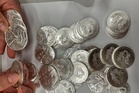 A tip about a swerving van leads police to 66,000 US silver coins in a fraud case