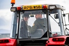 William and Kate drive tractor as they help locals with beach clean-up