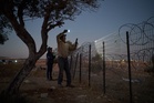 A flashlight and unseen settlers: Photographer conveys West Bank family's nightly watch in 1 photo