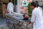 Gunmen target ambulance in Pakistan after suicide bombing at checkpoint killed 12
