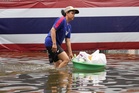 Rain eases in Bangkok but persistent flooding forces thousands to leave home