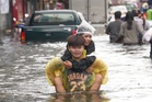 Photos show people navigating Bangkok’s flooded streets during days of heavy rain