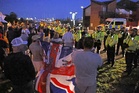 Protesters gather as migrant dinghy heads for south coast
