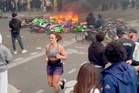 Unfazed jogger casually runs through chaotic Paris protests