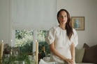 Meghan lights candle and fills champagne glass in festive As Ever celebrations