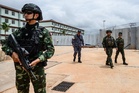 Cambodian police and military guards with shock batons linked to scam compounds