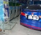 Woman crashes car into laundry shop after stepping on throttle