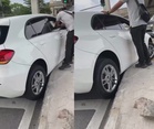 Strangers step in to help woman after car gets stuck on road divider