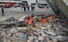 A painful wait by a pile of rubble in quake-hit Venezuela