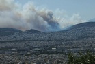 Greece wildfire reaches sea as winds batter coastal resort
