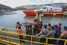 Rescuers comb waters near Bali for 5 missing after ferry blaze