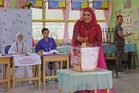 N.Sembilan polls: Bride turns heads as she votes in wedding attire