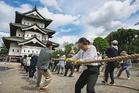 With ropes and chants, thousands move Japanese castle