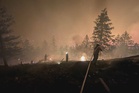 Wildfire forces 20,000 evacuations in western Canada as state of emergency declared